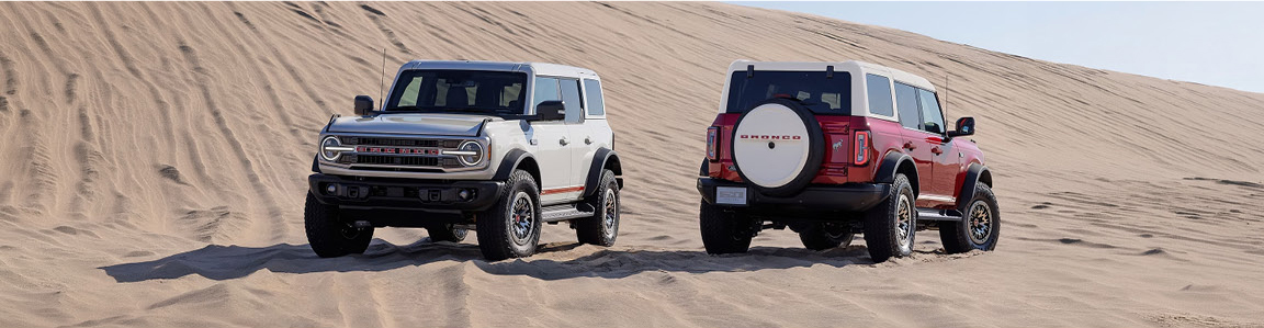 Ford Bronco off-road SUV in sand dunes showing front and rear views