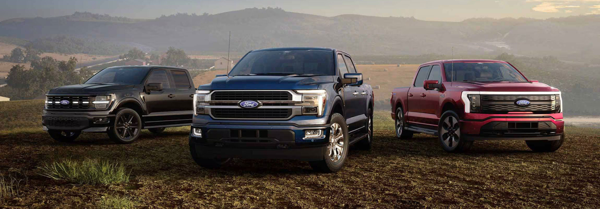 Ford F-150 pickup truck lineup shown in black, blue, and red on an open landscape