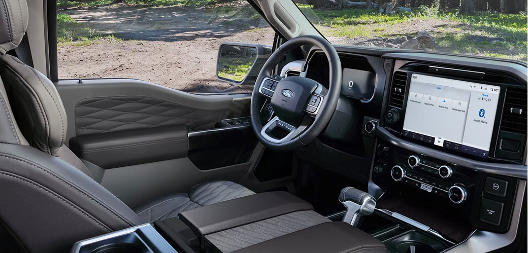 Ford pickup truck interior with digital touchscreen, center console, and steering wheel
