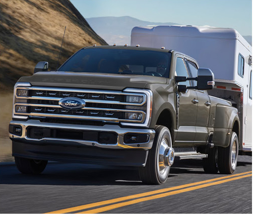Ford Super Duty heavy-duty truck towing a large RV trailer on the highway