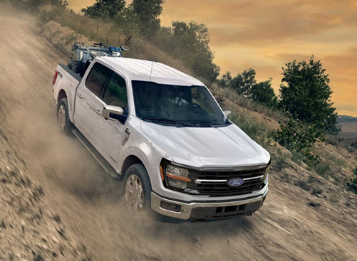 Ford F-150 navigating a rugged dirt trail demonstrating off-road confidence, durability, and all-terrain performance