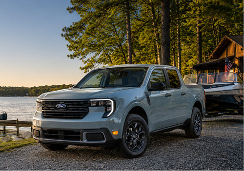 Ford F-150 parked near a lakeside cabin emphasizing everyday capability, recreation readiness, and rugged truck styling