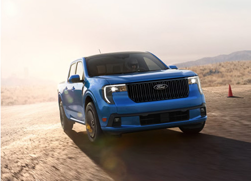 blue Ford Maverick Lobo street-performance pickup truck driving on a paved course