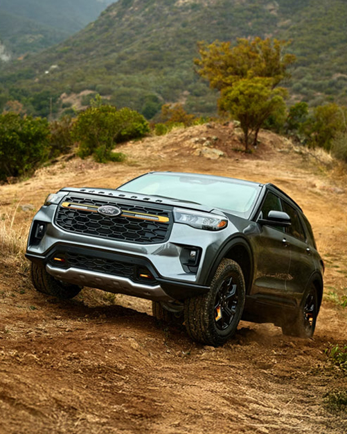 Ford Explorer Tremor SUV navigating rugged off-road terrain with enhanced capability features