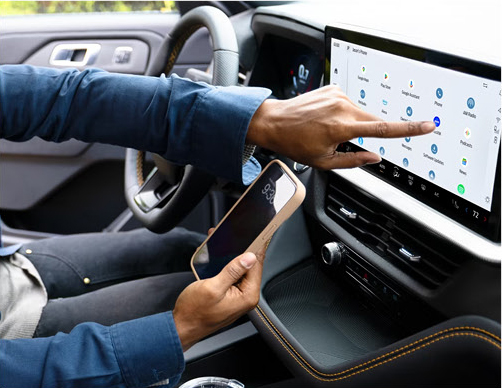 driver using Ford SYNC touchscreen infotainment system with smartphone integration and connected features