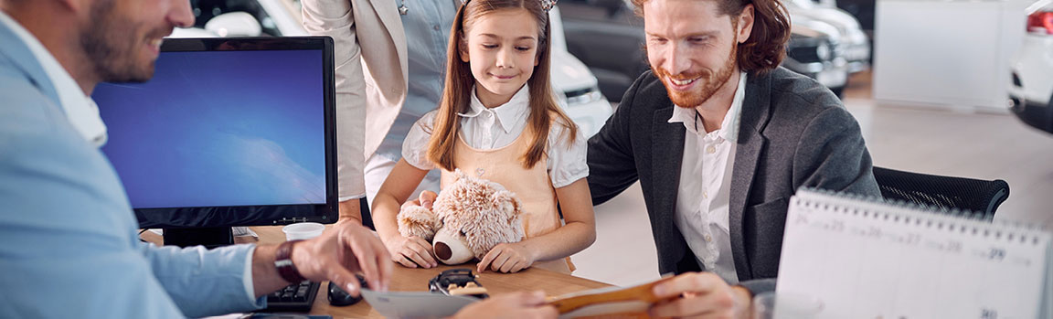 A family looking at a paperwork with a sales representative