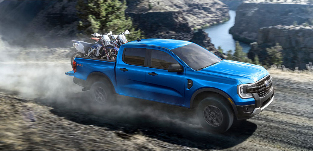 Ford Ranger FX4 pickup truck hauling dirt bikes on an off-road trail