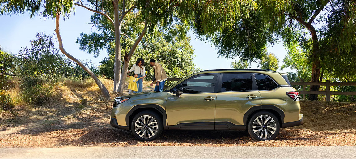 Subaru Forester Hybrid SUV parked outdoors with a family near a park