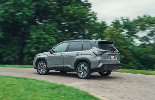 Rear three quarter view of Subaru Forester Hybrid driving on a curving road