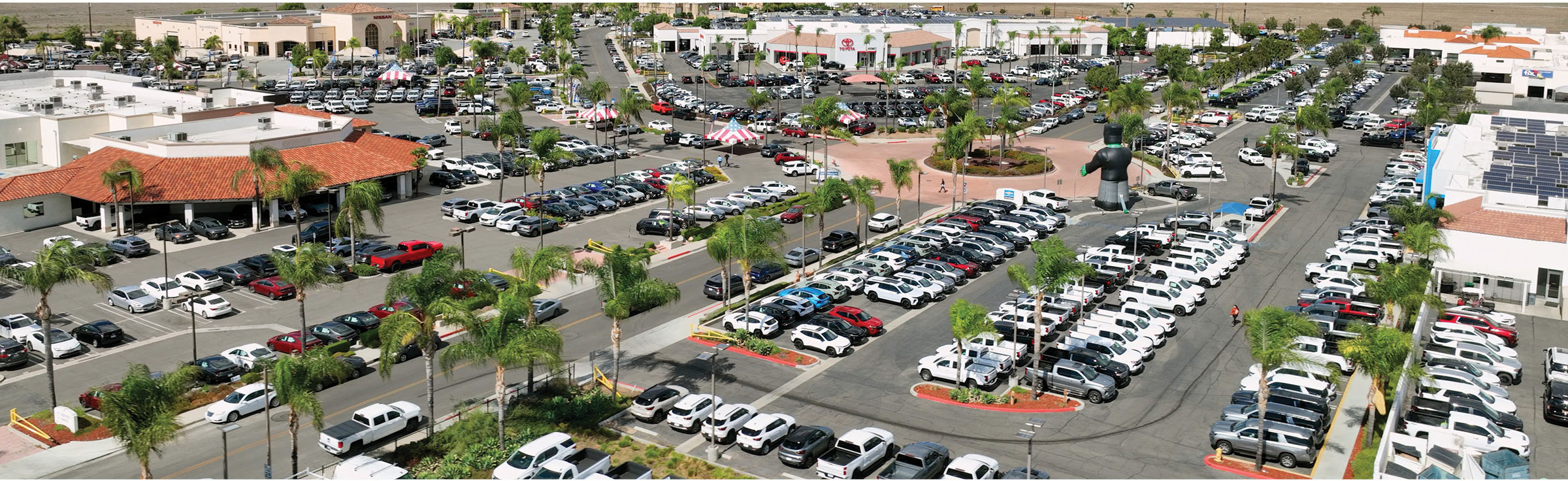 Aerial view of large auto dealership with extensive vehicle inventory