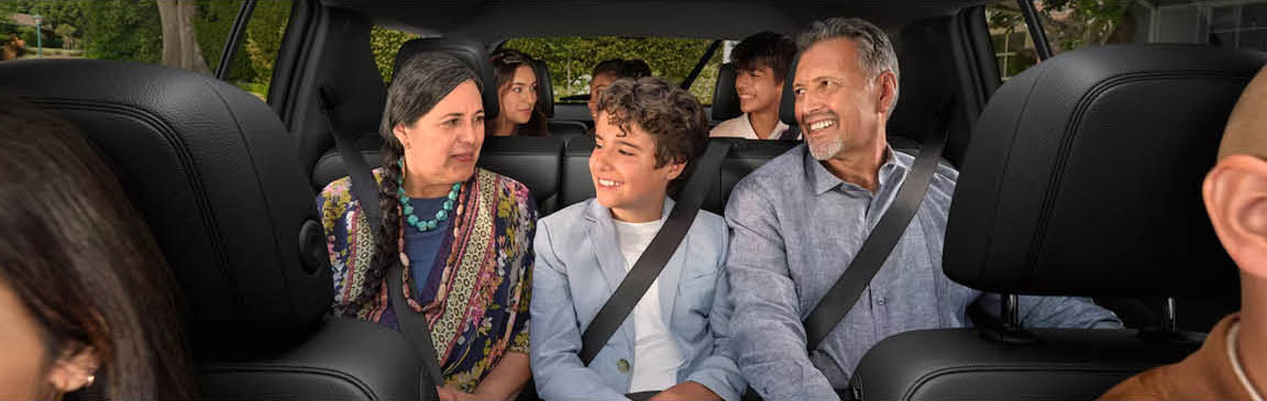 family enjoying spacious third-row seating inside SUV