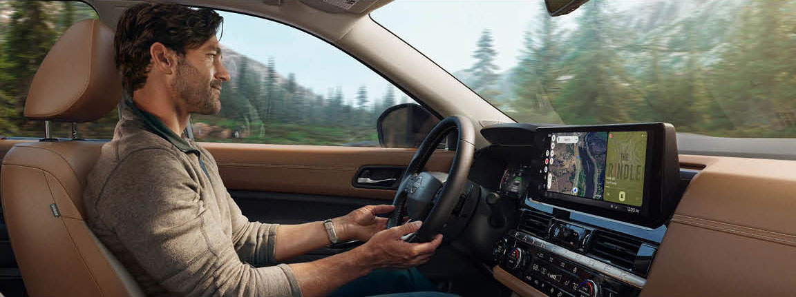driver using touchscreen infotainment system inside modern SUV