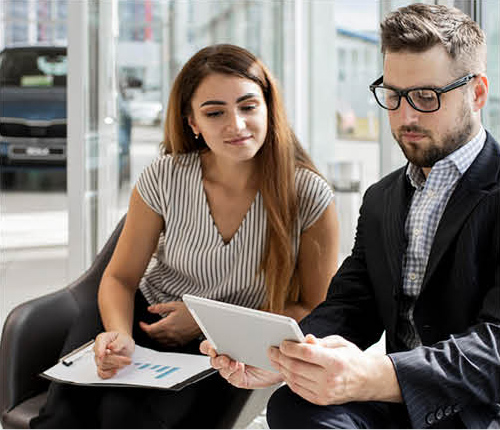 Customer discussing auto financing options with a dealership representative