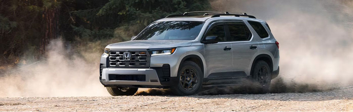 Honda Pilot TrailSport driving on dirt road demonstrating off-road performance