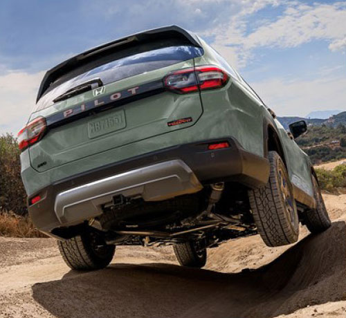 Honda Pilot off-roading on rugged terrain showcasing AWD capability