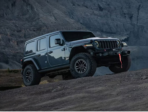 Jeep Wrangler Rubicon off-road SUV parked on a rugged rocky landscape