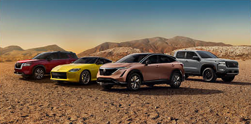 Cadillac Lyriq electric SUV shown with other Cadillac vehicles in a desert landscape