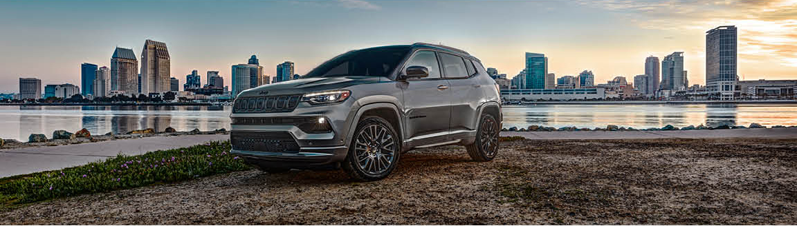 Jeep Compass SUV parked near a waterfront city skyline