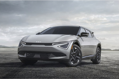 Kia EV6 electric crossover parked on an open road showcasing sleek aerodynamic styling