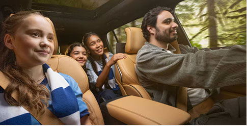 A family inside of a Jeep vehicle