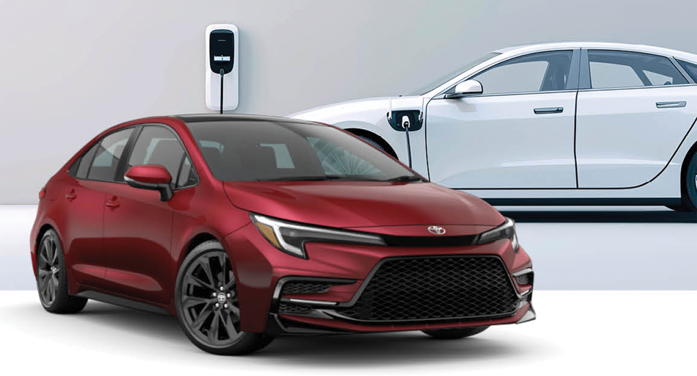 Red Toyota Corolla sedan parked next to a white electric car charging