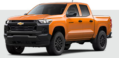 Chevrolet Colorado midsize pickup truck in orange on light background