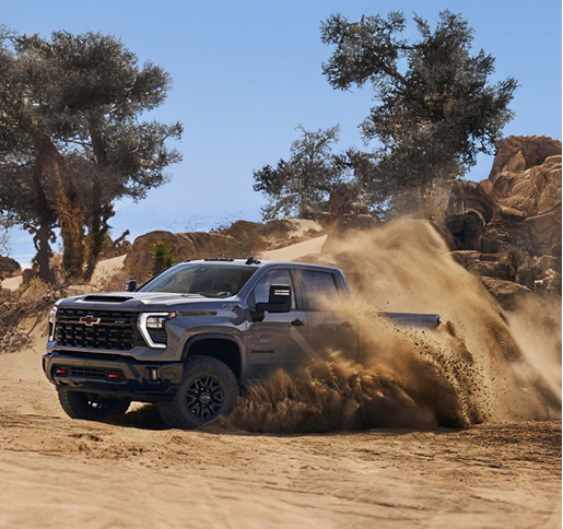 Chevrolet Silverado HD driving off-road in sandy desert terrain
