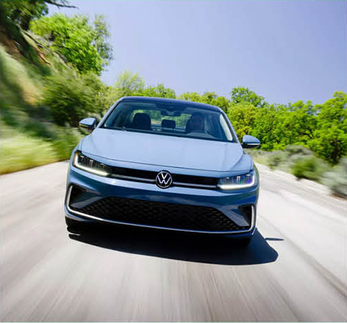 Front view of Volkswagen Jetta driving on a winding road