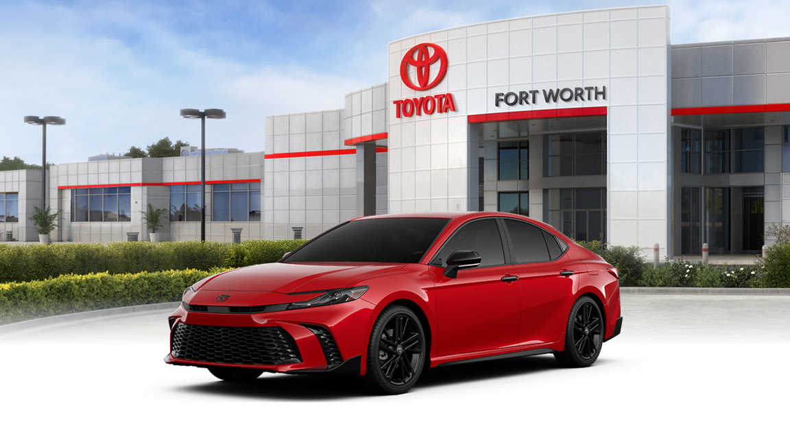 Toyota dealership in Fort Worth with red Toyota Camry parked in front