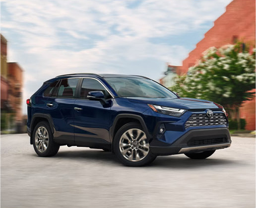 Toyota RAV4 hybrid SUV driving through an urban neighborhood