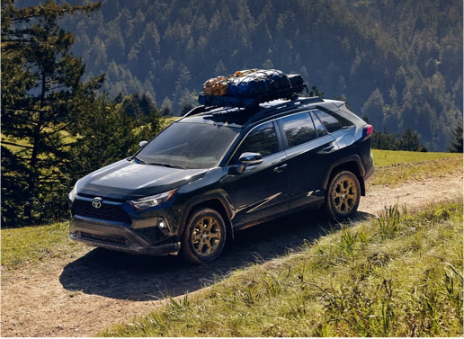 Toyota RAV4 hybrid SUV driving off road on a mountain trail