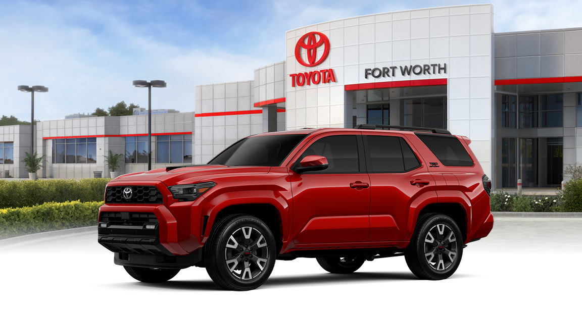 red Toyota 4Runner parked in front of Toyota dealership in Fort Worth