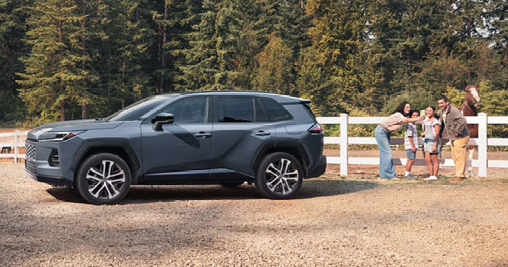Toyota Grand Highlander parked outdoors with a family preparing for a road trip adventure