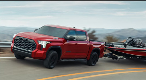 Toyota Tundra towing a bass boat on the highway demonstrating powerful towing performance, recreational versatility, and long-distance hauling confidence