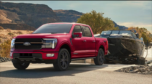 Ford F-150 towing a high-performance boat through desert terrain showcasing impressive towing capability and full-size truck strength