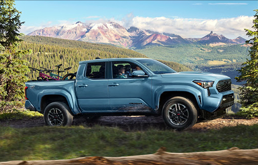 Toyota Tacoma TRD Sport driving through a mountain landscape highlighting midsize truck versatility, capability, and outdoor lifestyle appeal