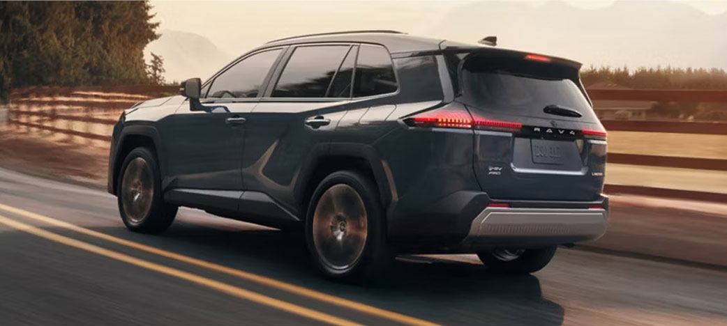 Toyota SUV rear view driving on a highway at sunset