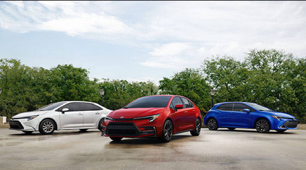 Toyota Corolla sedan, GR Corolla hatchback, and Corolla Hatchback lineup on an outdoor pavement