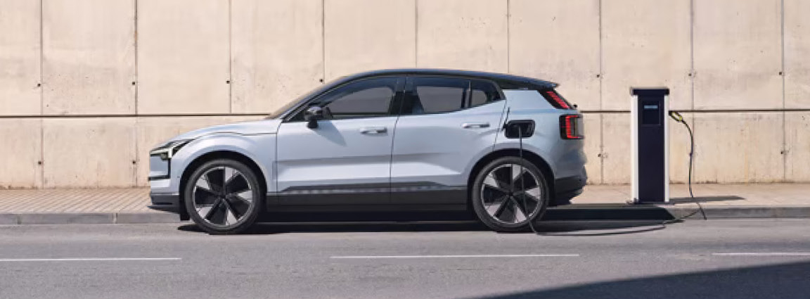Volvo EX30 connected to a charging station, highlighting electric vehicle convenience, charging technology, and sustainable mobility