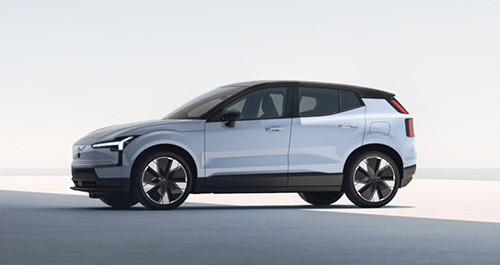 Side profile of the Volvo EX30 featuring compact SUV proportions, aerodynamic styling, and modern electric vehicle design