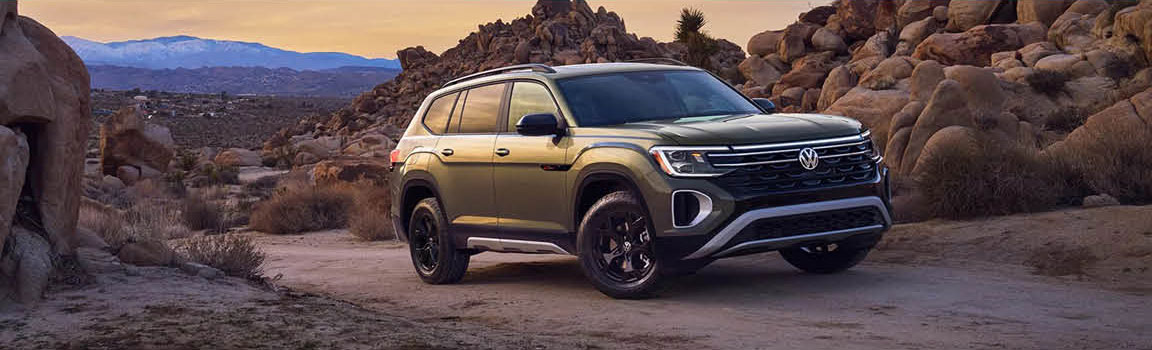 Volkswagen Atlas SUV parked in rugged desert landscape
