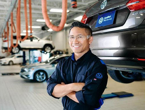 Volkswagen certified technician standing in auto service center