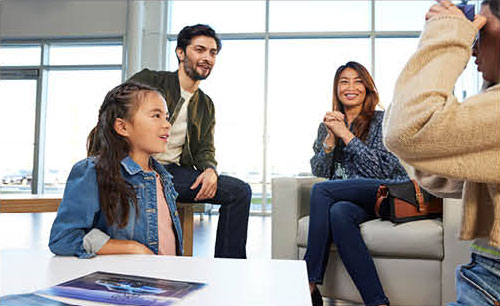 Family waiting in comfortable dealership service lounge