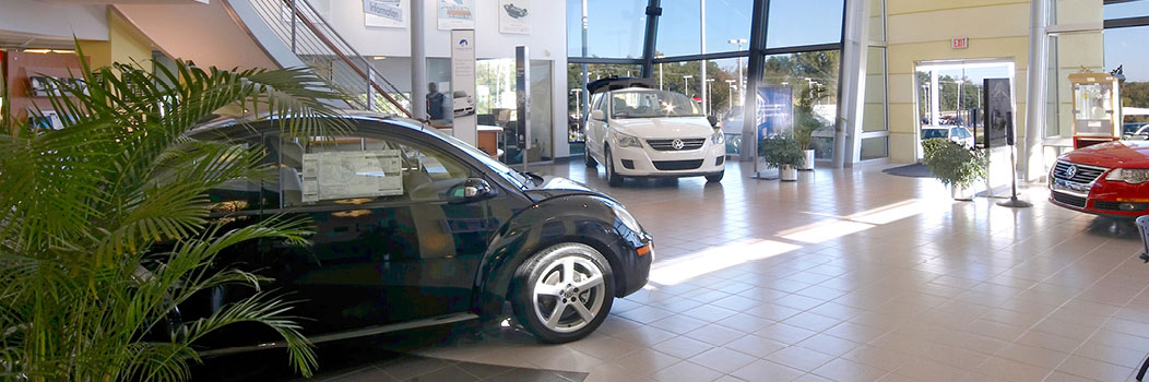 Volkswagen showroom interior with vehicles on display and modern dealership space