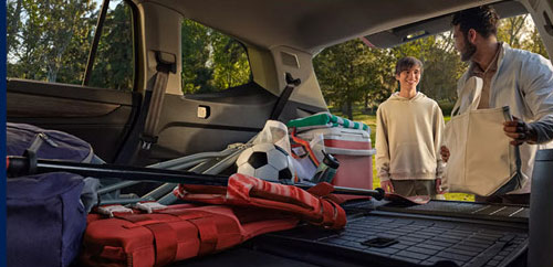 Volkswagen Atlas cargo space with family loading sports gear and bags in trunk