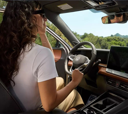 Driver enjoying the premium interior and digital cockpit of the 2025 Volkswagen Tiguan