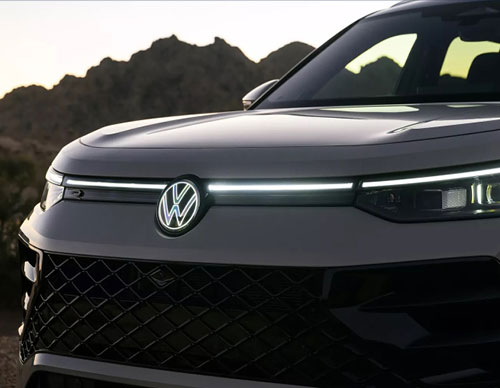 Close-up of the 2026 Volkswagen Tiguan front grille, LED light bar, and illuminated Volkswagen emblem