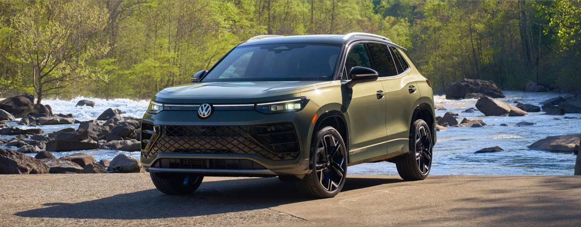 2026 Volkswagen Tiguan parked beside a river showcasing exterior styling, wheels, and outdoor-ready design