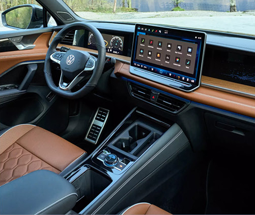 Premium Volkswagen interior with large touchscreen display, upscale materials, connected technology, and modern comfort features