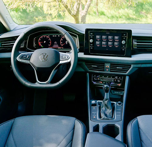 Volkswagen Jetta interior featuring a digital cockpit, touchscreen infotainment system, and driver-focused cabin layout